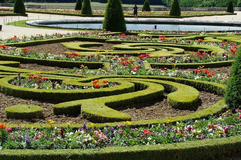 Versailles’ chateau gardens are famous for their geometrically aligned terraces, luxuriant tree-lined paths, quiet ponds, and canals.