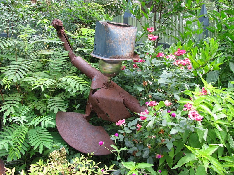Rushing is a big believer in reducing, reusing, and recycling. His yard décor might strike an uninitiated visitor as an aimless jumble of salvaged materials and junk. 