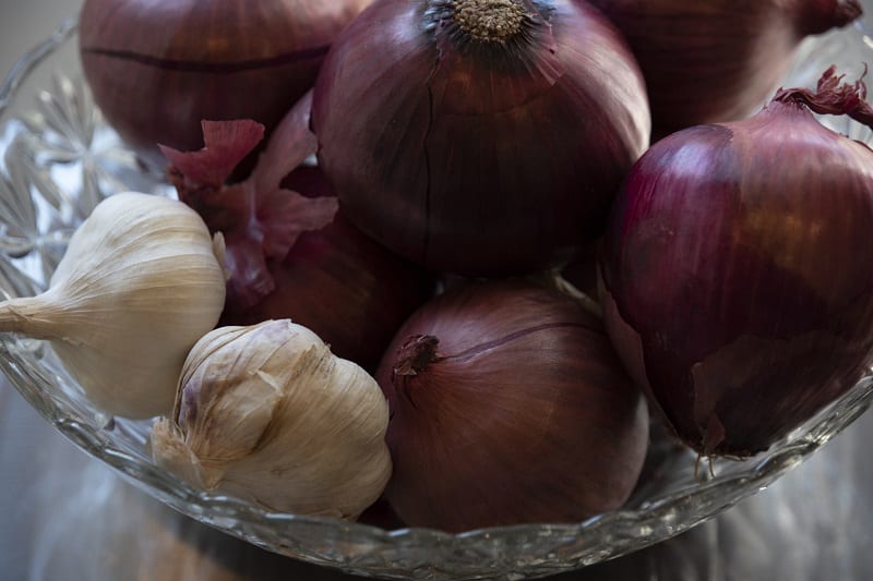 Onion and garlic grow beneath the surface of the ground and prefer a sandy habitat. 