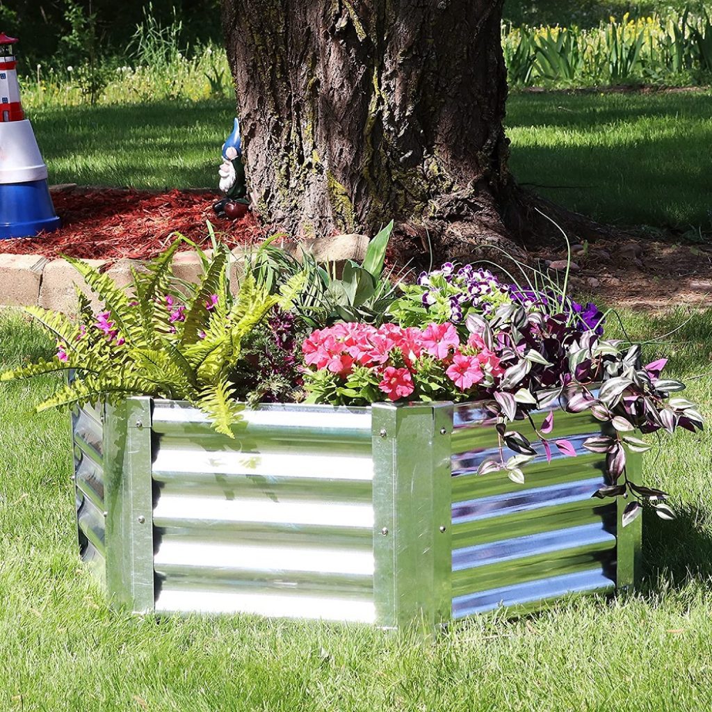 One of the attractive galvanized garden beds. It's overflowing with plants and flowers.