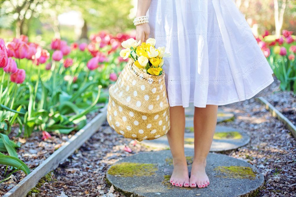 A woman in bare feet after gardening.