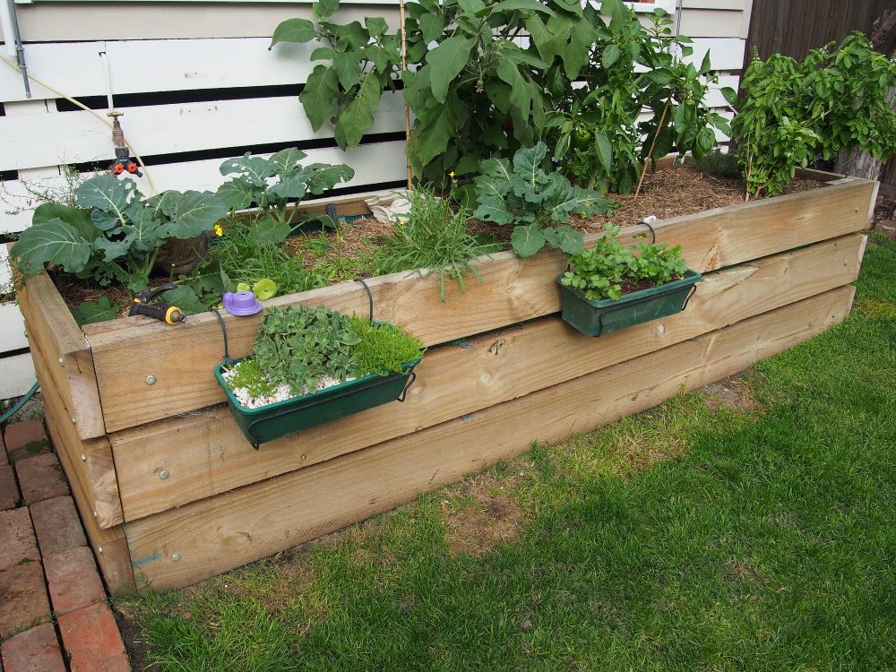 A raised garden bed with planters.