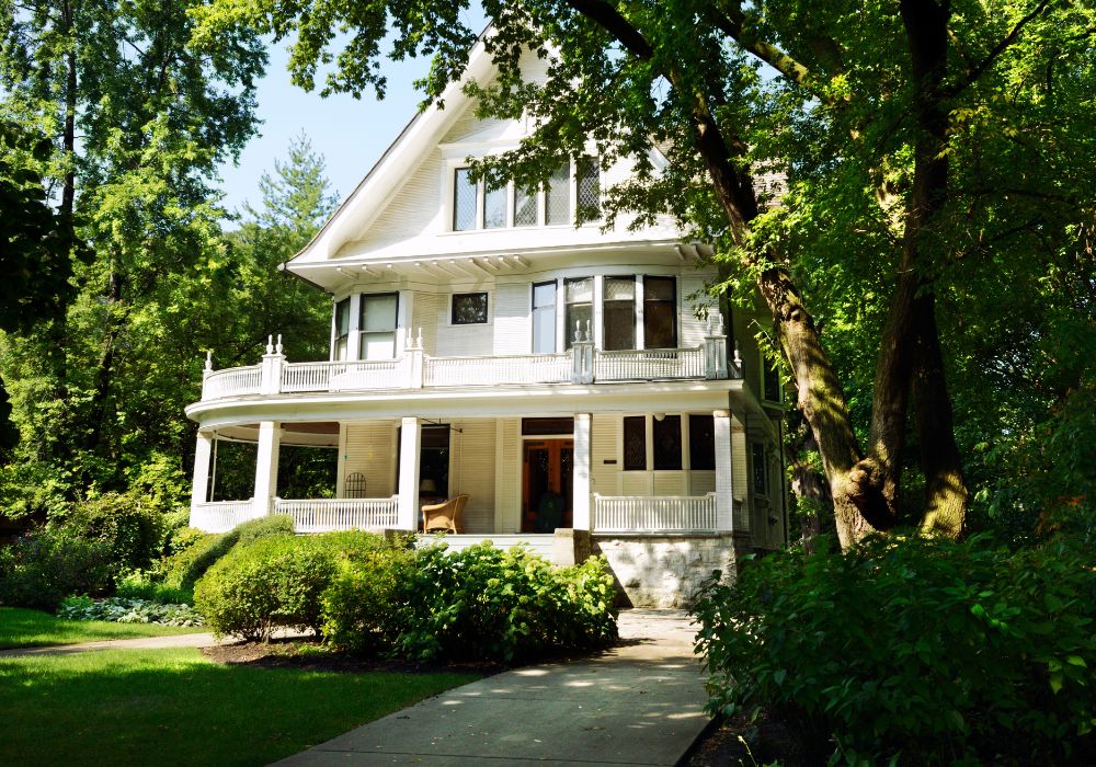 An image of oak trees growing beside a house.